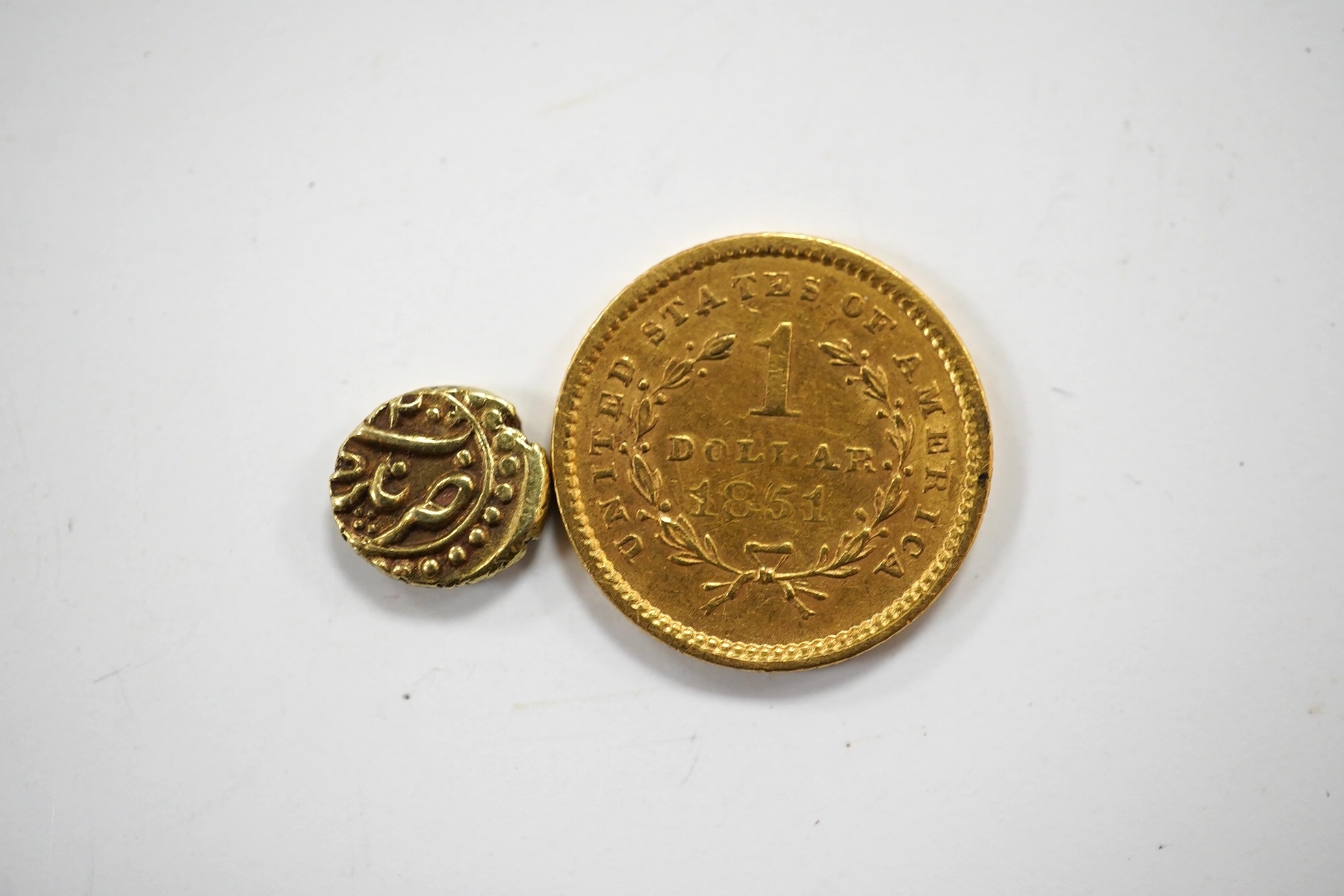 Gold coins, an early 19th Indian half rupee and USA 1851 one dollar